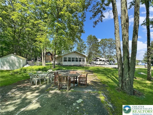 7537 Lake Shore Dr, Tobyhanna Twp, PA 18347 - view of green lawn featuring a patio and outdoor dining space