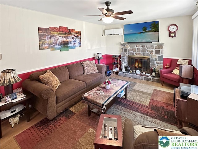 7537 Lake Shore Dr, Tobyhanna Twp, PA 18347 - living area with an AC wall unit, ceiling fan, wood finished floors, and a stone fireplace