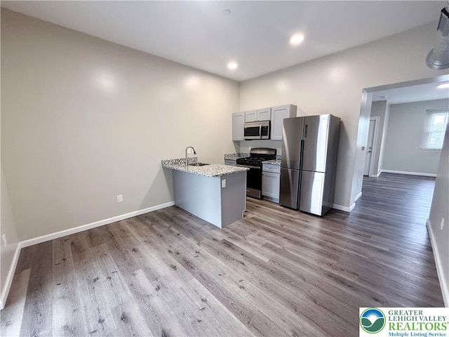 801 W Broad, Bethlehem City, PA 18018 - kitchen with stainless steel appliances, a peninsula, light wood-type flooring, and recessed lighting
