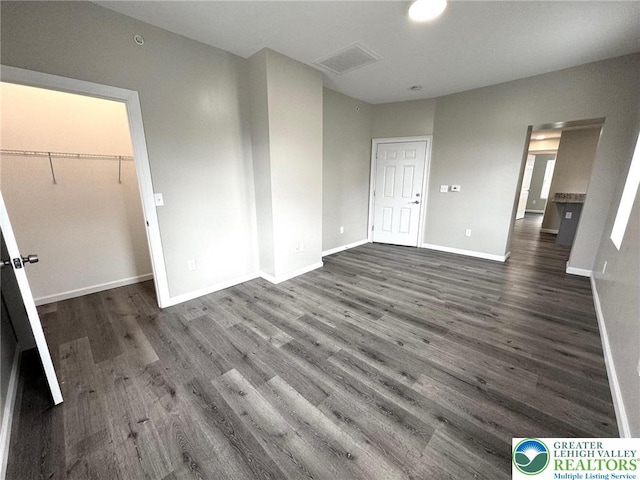 801 W Broad, Bethlehem City, PA 18018 - unfurnished bedroom featuring dark wood finished floors and a walk in closet