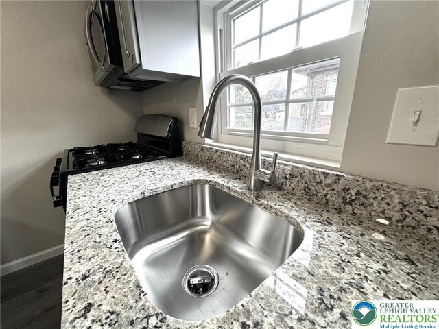 801 W Broad, Bethlehem City, PA 18018 - kitchen view of light stone countertops and black range with gas stovetop