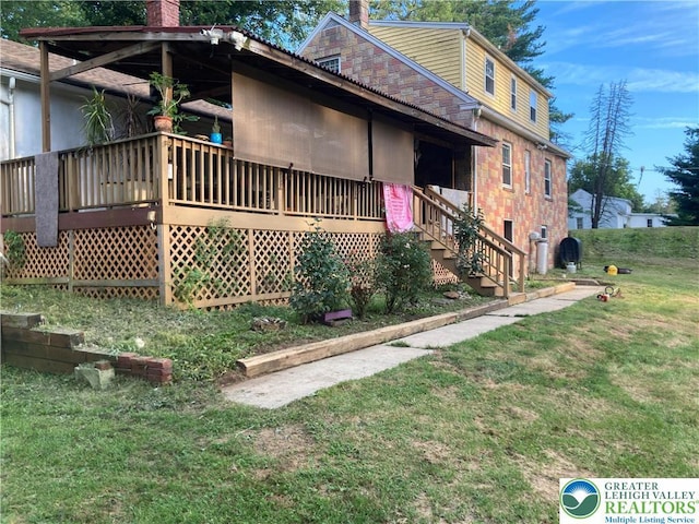 5984 Rte 412, Springfield Twp, PA 18077 - view of home's exterior with a chimney, a lawn, and a deck