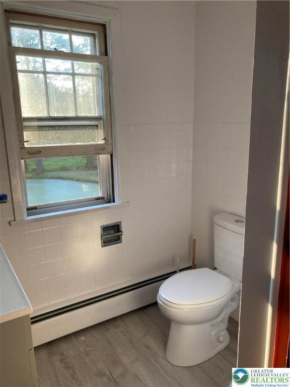 5984 Rte 412, Springfield Twp, PA 18077 - bathroom featuring baseboard heating, tile walls, and wood finished floors
