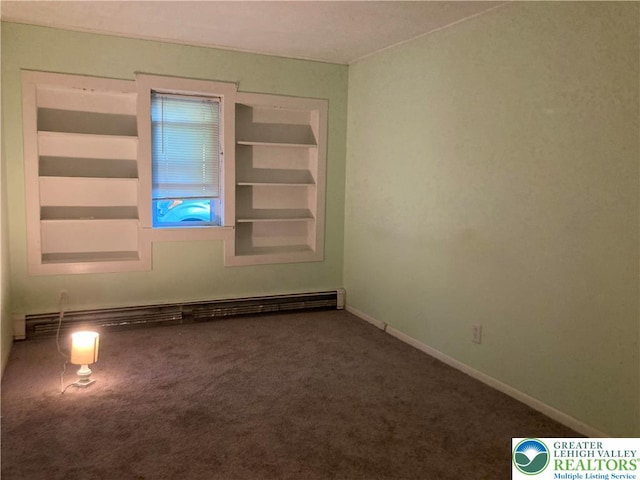 5984 Rte 412, Springfield Twp, PA 18077 - spare room featuring a baseboard heating unit, carpet, and built in shelves