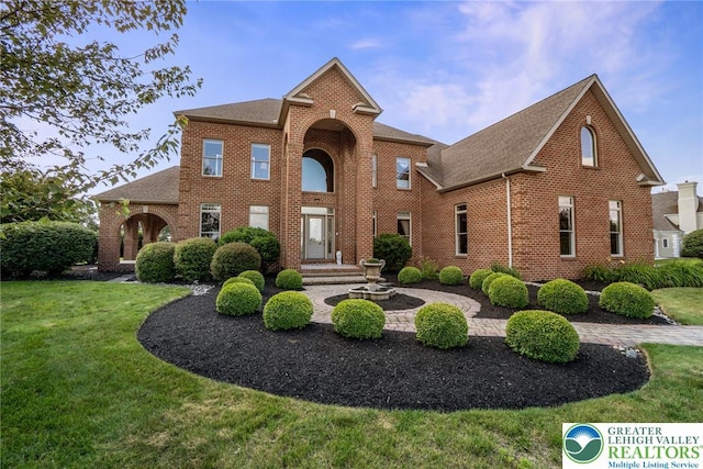 4260 W Wyndemere Cir, Lowhill Twp, PA 18078 - traditional-style house with brick siding, a front yard, and roof with shingles