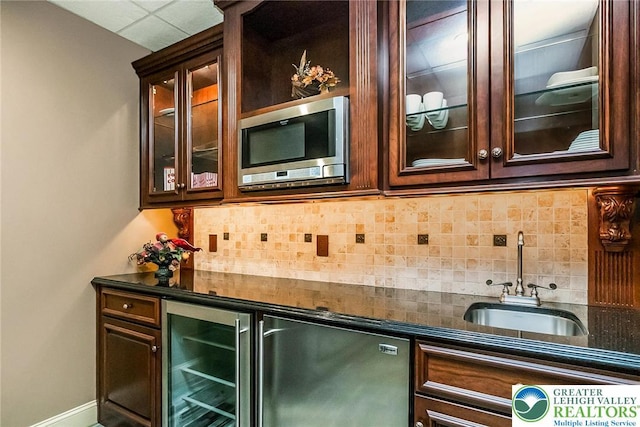 4260 W Wyndemere Cir, Lowhill Twp, PA 18078 - indoor wet bar featuring stainless steel microwave, wine cooler, refrigerator, and backsplash