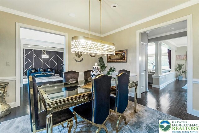 4260 W Wyndemere Cir, Lowhill Twp, PA 18078 - dining space featuring wood finished floors, ornamental molding, a chandelier, and ornate columns