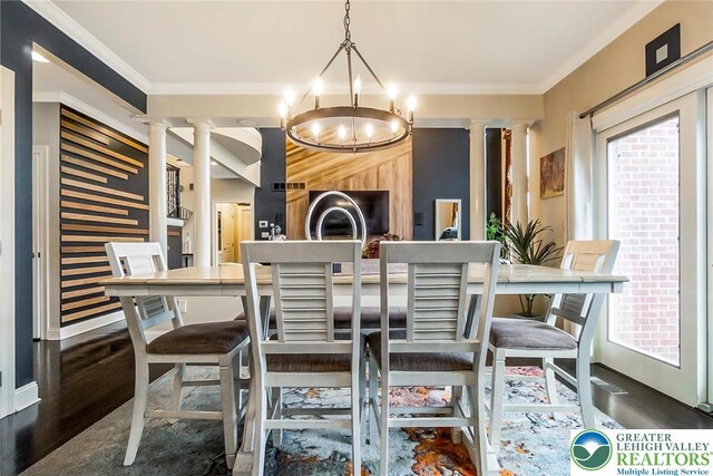 4260 W Wyndemere Cir, Lowhill Twp, PA 18078 - dining area with decorative columns, a chandelier, ornamental molding, and wood finished floors