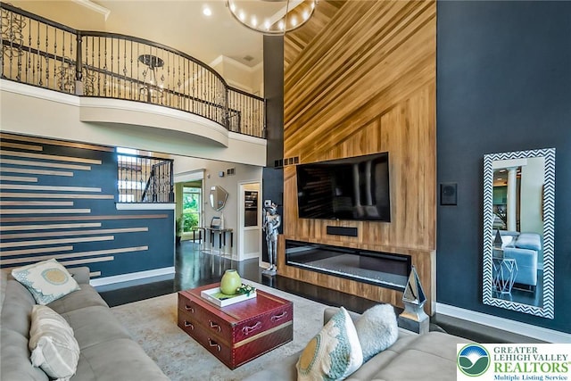 4260 W Wyndemere Cir, Lowhill Twp, PA 18078 - living area with a high ceiling, wooden walls, and ornamental molding