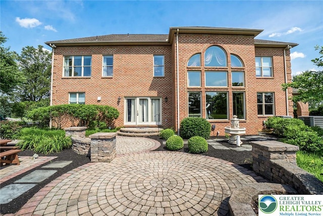 4260 W Wyndemere Cir, Lowhill Twp, PA 18078 - rear view of house featuring brick siding and a patio area
