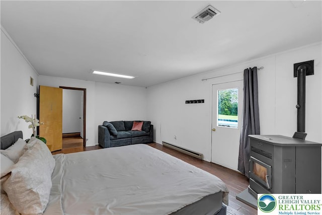 8555 Mohr Ln, Weisenberg Twp, PA 18051 - bedroom with a wood stove, a baseboard radiator, and wood finished floors