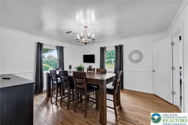 8555 Mohr Ln, Weisenberg Twp, PA 18051 - dining space with a chandelier, ornamental molding, and hardwood / wood-style floors