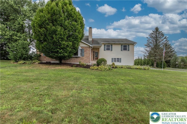 8555 Mohr Ln, Weisenberg Twp, PA 18051 - view of front of house featuring a chimney, a front lawn, and brick siding
