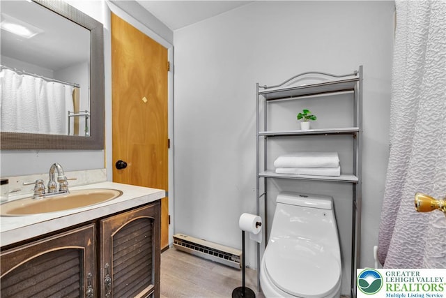 8555 Mohr Ln, Weisenberg Twp, PA 18051 - full bath with a baseboard radiator, vanity, and wood finished floors