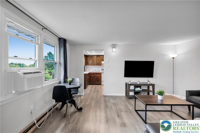 8555 Mohr Ln, Weisenberg Twp, PA 18051 - living area featuring light wood-style floors, cooling unit, and a baseboard radiator