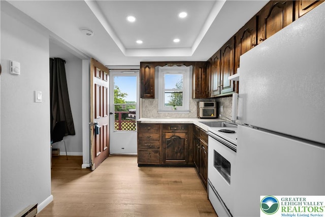 8555 Mohr Ln, Weisenberg Twp, PA 18051 - kitchen featuring white appliances, a baseboard heating unit, light wood-type flooring, dark brown cabinets, and recessed lighting