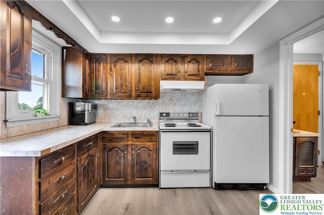 8555 Mohr Ln, Weisenberg Twp, PA 18051 - kitchen featuring white appliances, under cabinet range hood, light countertops, light wood finished floors, and a raised ceiling