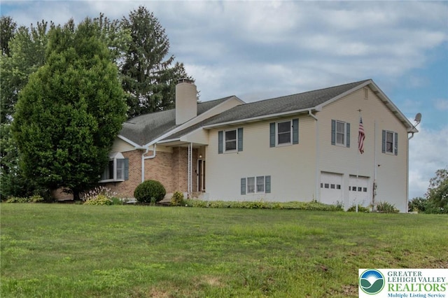 8555 Mohr Ln, Weisenberg Twp, PA 18051 - split level home with a chimney, an attached garage, a front yard, and brick siding