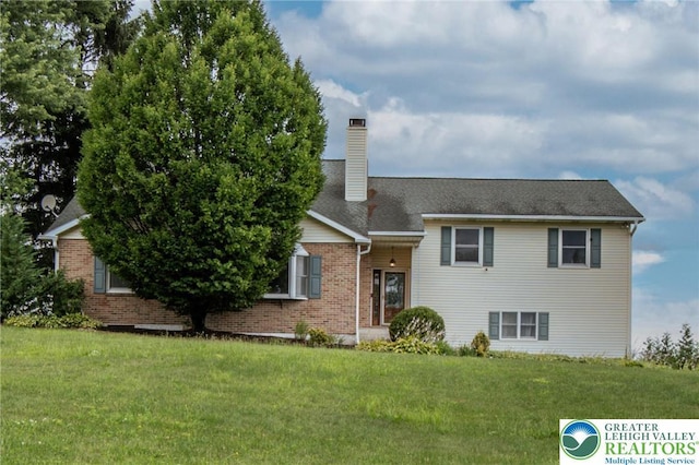 8555 Mohr Ln, Weisenberg Twp, PA 18051 - tri-level home with a front yard, brick siding, a chimney, and a shingled roof