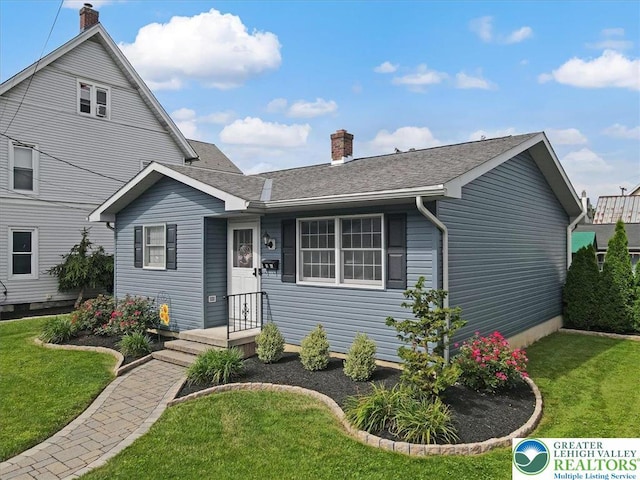 5129 3rd St, Whitehall Twp, PA 18052 - view of front of house featuring a chimney, a front yard, and a shingled roof