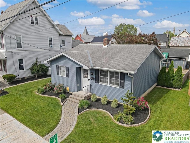 5129 3rd St, Whitehall Twp, PA 18052 - view of front of house featuring a shingled roof and a front lawn