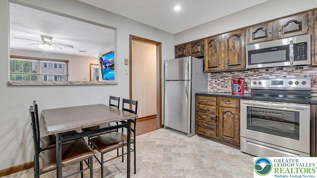 5129 3rd St, Whitehall Twp, PA 18052 - kitchen with appliances with stainless steel finishes, decorative backsplash, dark countertops, and ceiling fan