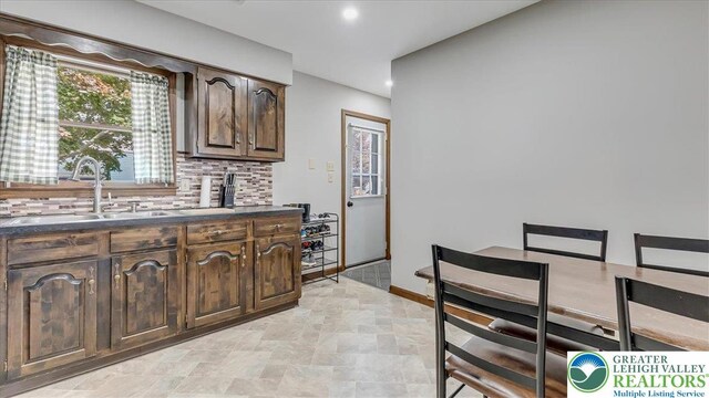 5129 3rd St, Whitehall Twp, PA 18052 - kitchen featuring dark countertops, decorative backsplash, dark brown cabinets, and recessed lighting