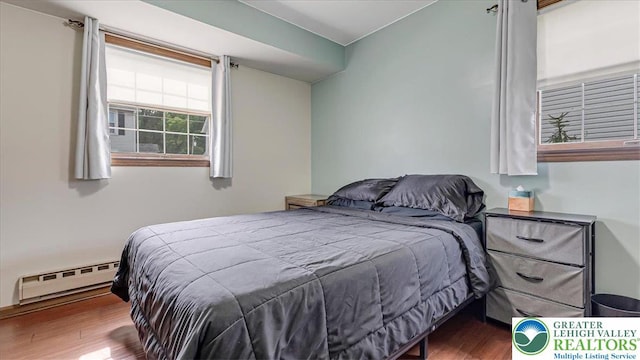 5129 3rd St, Whitehall Twp, PA 18052 - bedroom featuring a baseboard heating unit and wood finished floors