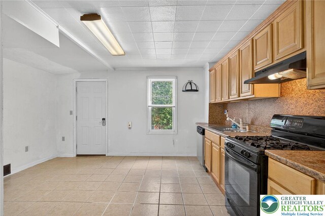 22 N Warren St, Easton, PA 18042 - kitchen with black gas range oven, under cabinet range hood, dishwasher, decorative backsplash, and light tile patterned flooring
