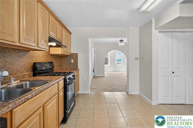 22 N Warren St, Easton, PA 18042 - kitchen featuring black gas range, under cabinet range hood, arched walkways, backsplash, and crown molding