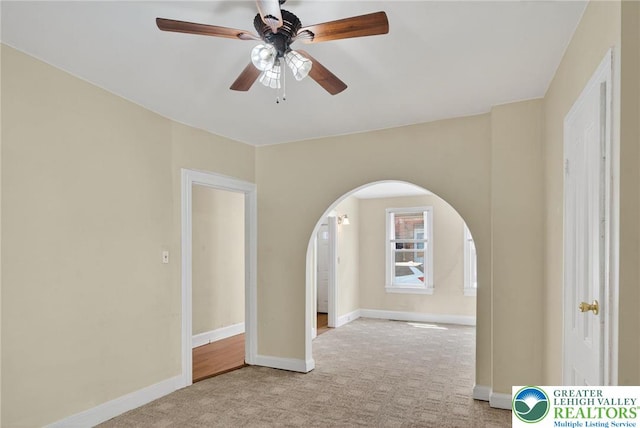 22 N Warren St, Easton, PA 18042 - carpeted empty room with arched walkways and ceiling fan