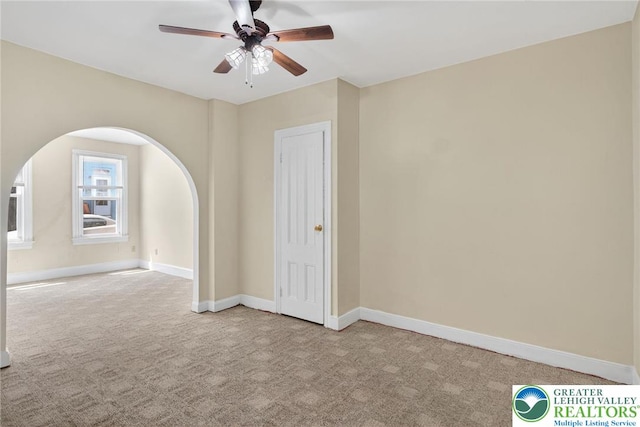 22 N Warren St, Easton, PA 18042 - empty room featuring carpet floors, arched walkways, and a ceiling fan