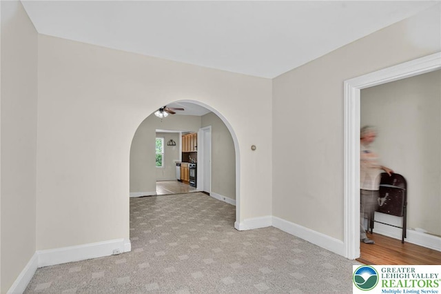 22 N Warren St, Easton, PA 18042 - spare room featuring arched walkways, ceiling fan, and light colored carpet