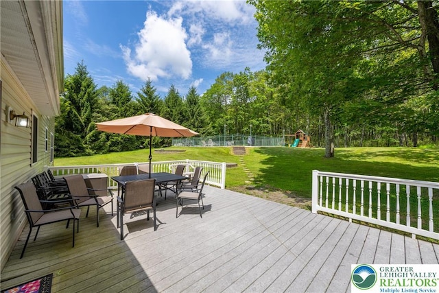 2175 Village Rd, Chestnuthill Twp, PA 18330 - wooden terrace with outdoor dining space, a playground, and view of scattered trees