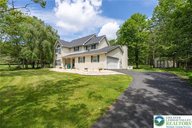 2175 Village Rd, Chestnuthill Twp, PA 18330 - view of front facade with a shed, a garage, driveway, a front lawn, and a chimney