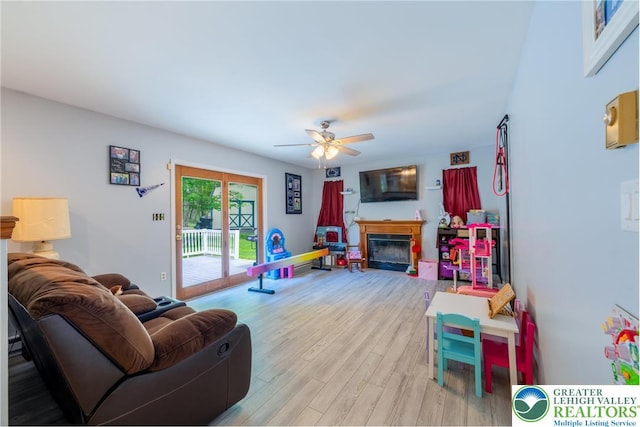 2175 Village Rd, Chestnuthill Twp, PA 18330 - living room featuring a ceiling fan, wood finished floors, and a glass covered fireplace