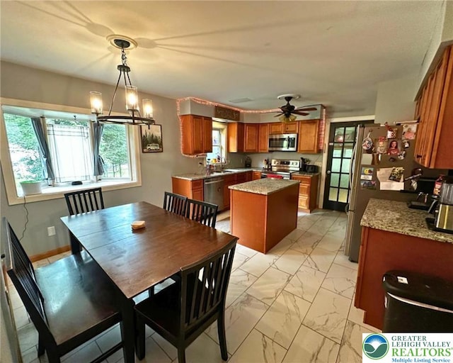1701 Johns Rd, Chestnuthill Twp, PA 18330 - dining space with healthy amount of natural light, light marble finish floors, a chandelier, and ceiling fan