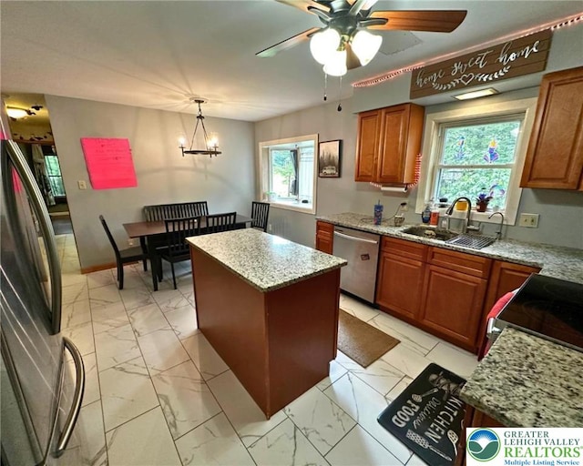 1701 Johns Rd, Chestnuthill Twp, PA 18330 - kitchen featuring stainless steel dishwasher, freestanding refrigerator, light marble finish flooring, brown cabinets, and a kitchen island