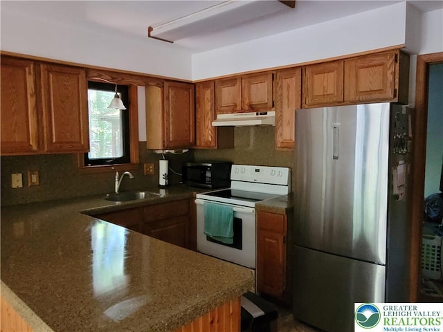 2048 Beaver Run Rd, Tobyhanna Twp, PA 18347 - kitchen with freestanding refrigerator, electric range, under cabinet range hood, black microwave, and brown cabinets
