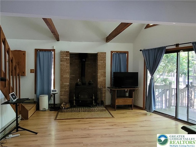 2048 Beaver Run Rd, Tobyhanna Twp, PA 18347 - living area featuring light wood-style flooring, a baseboard heating unit, and a wood stove