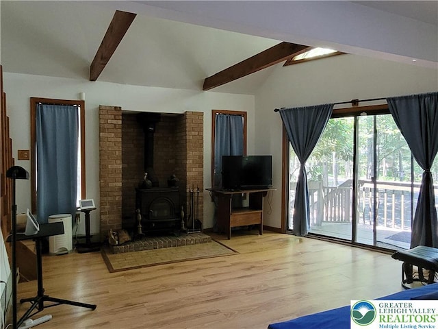 2048 Beaver Run Rd, Tobyhanna Twp, PA 18347 - unfurnished living room featuring beam ceiling, wood finished floors, a wood stove, and high vaulted ceiling