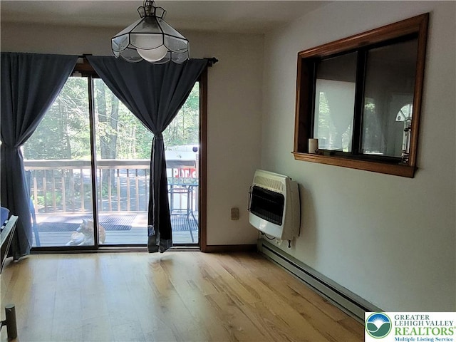 2048 Beaver Run Rd, Tobyhanna Twp, PA 18347 - unfurnished dining area with heating unit, baseboard heating, and light wood-style floors