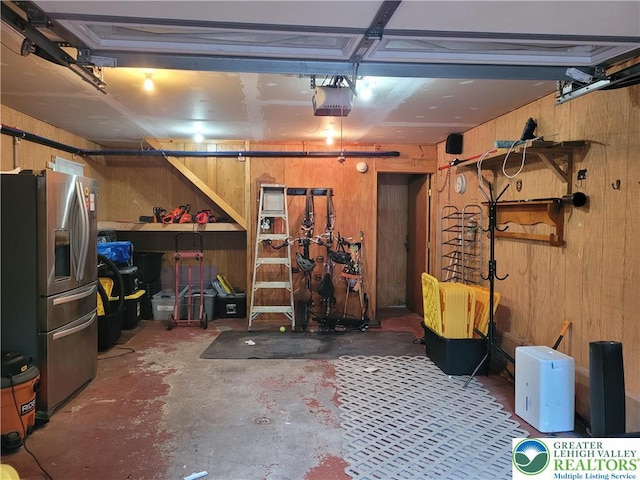 2048 Beaver Run Rd, Tobyhanna Twp, PA 18347 - garage featuring stainless steel fridge, wooden walls, and a garage door opener