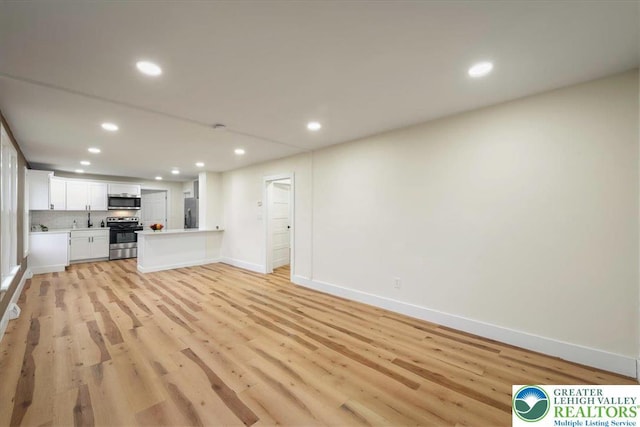 428 Shook Ave, Stroud Twp, PA 18360 - unfurnished living room with recessed lighting and light wood finished floors