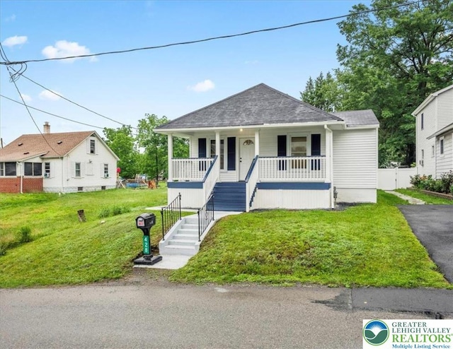 428 Shook Ave, Stroud Twp, PA 18360 - bungalow-style house featuring a porch, stairs, a front lawn, a shingled roof, and asphalt driveway