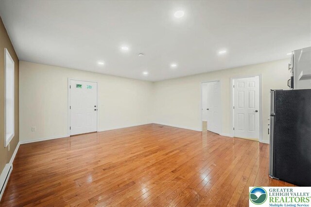 428 Shook Ave, Stroud Twp, PA 18360 - unfurnished living room with light wood-style flooring, recessed lighting, and a baseboard radiator