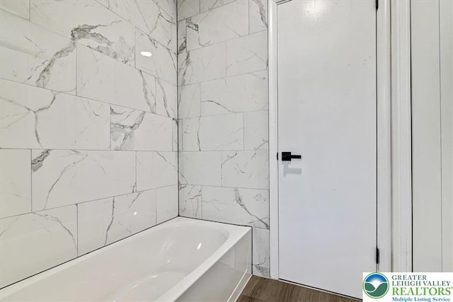 182 Maxatawny Dr, Coolbaugh Twp, PA 18347 - bathroom featuring a tub to relax in and wood finished floors