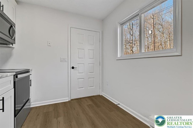 182 Maxatawny Dr, Coolbaugh Twp, PA 18347 - kitchen with stainless steel appliances, dark wood-style floors, white cabinetry, and light countertops