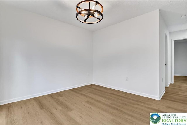 182 Maxatawny Dr, Coolbaugh Twp, PA 18347 - unfurnished room with a chandelier and wood finished floors