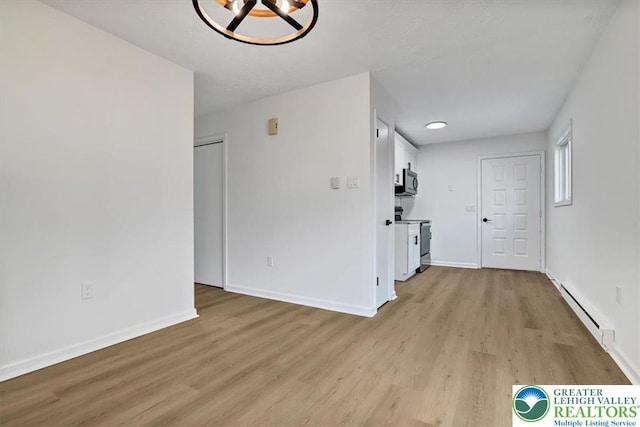 182 Maxatawny Dr, Coolbaugh Twp, PA 18347 - unfurnished room with a baseboard heating unit and light wood-style floors